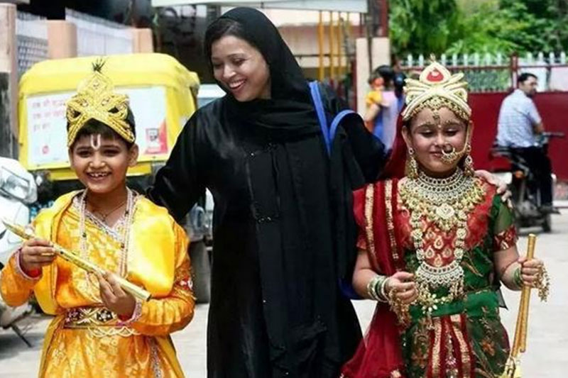 A Muslim woman with her children dressed as Lord Krishna and Radha.
